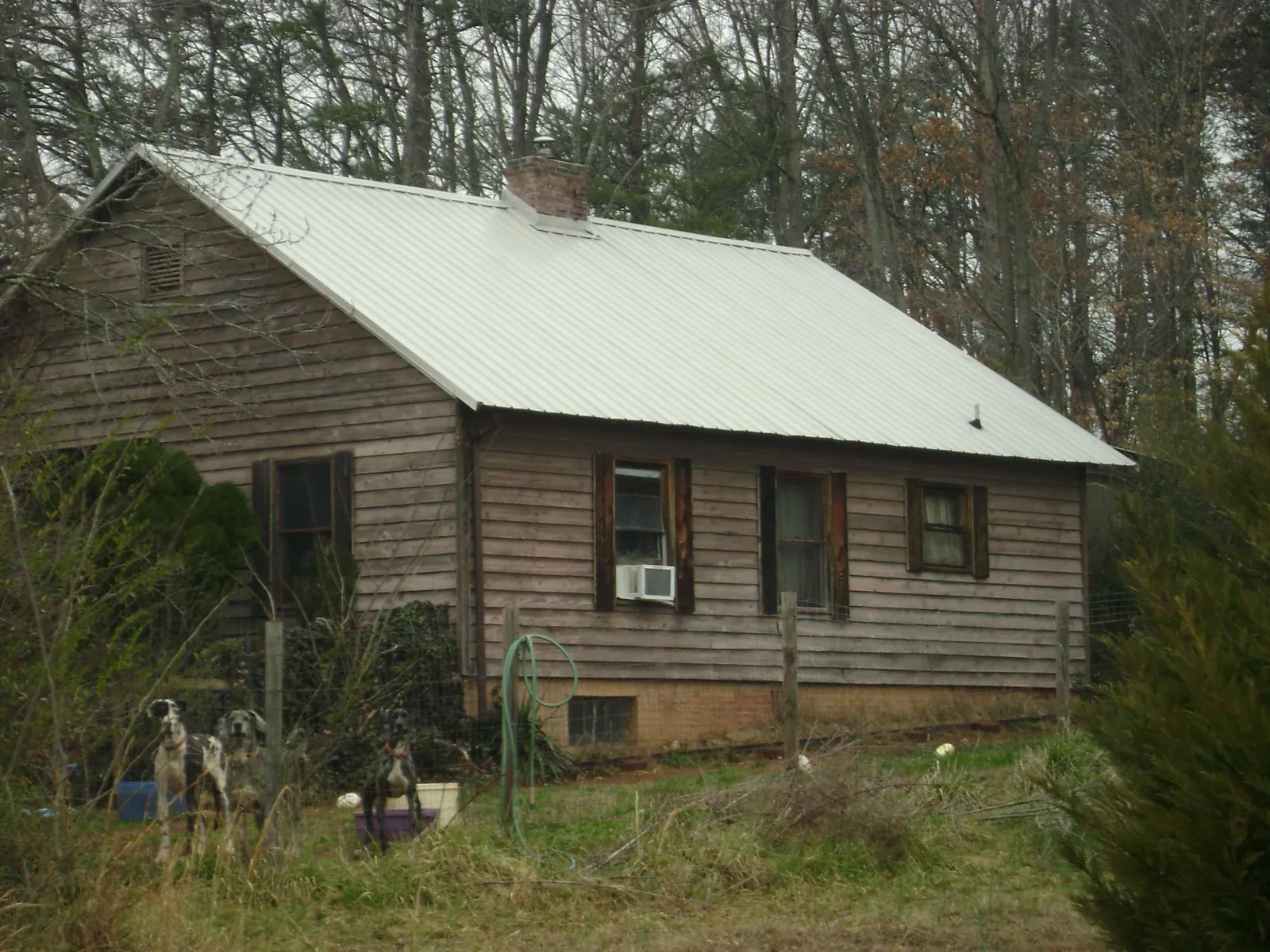 White metal roof on an old wood sided farmhouse, from a Metal Roof Installation job in New Ulm